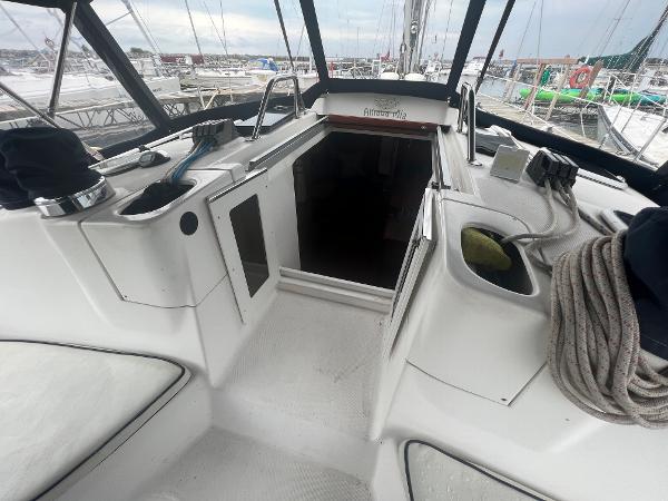 Slide: The Image of Cockpit of 2000 Hunter 410 sailboat with ropes and open cabin entrance. - 25
