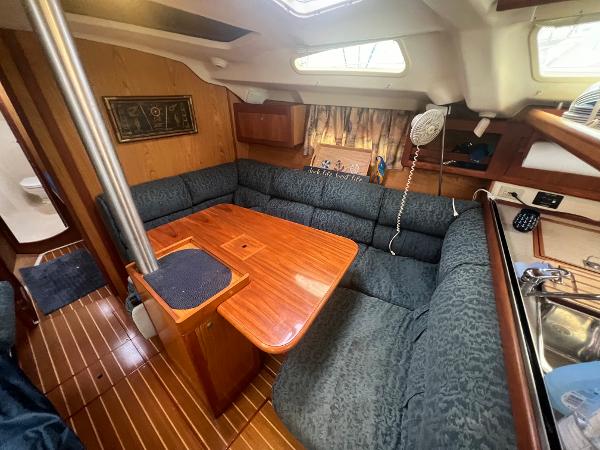 Slide: The Image of Cozy interior of 2000 Hunter 410 sailboat with wood accents and plush seating. - 30