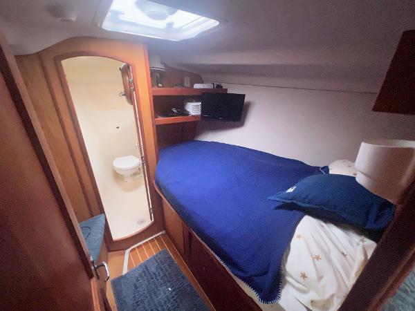 Slide: The Image of Cozy cabin interior of 2000 Hunter 410 yacht with bed, TV, and bathroom. - 32