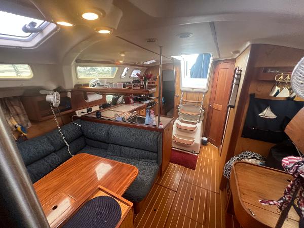 Slide: The Image of Interior of 2000 Hunter 410 sailboat with wood finish and cozy seating area. - 36