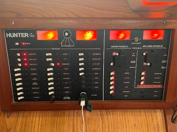 Slide: The Image of Electrical control panel of a 2000 Hunter 410 boat with switches and indicators. - 47