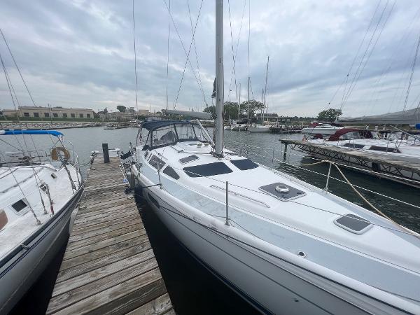 Slide: The Image of Sailboat docked at marina, Hunter 410 model, year 2000, under cloudy sky. - 7