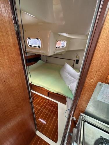 Slide: The Image of 1992 Hunter Legend 37 sailboat interior cabin with bed and wooden flooring. - 12