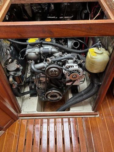 Slide: The Image of 1992 Hunter Legend 37 engine compartment with visible components and wooden flooring. - 16