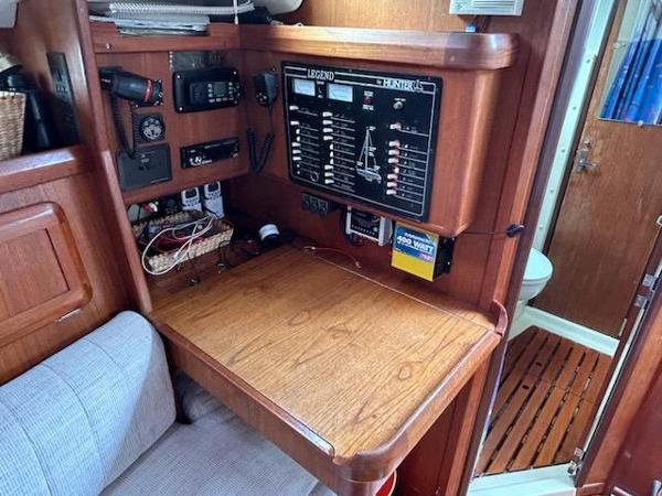 Slide: The Image of Navigation station of a 1992 Hunter Legend 37 sailboat with control panel and equipment. - 18