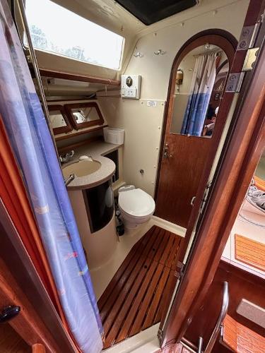 Slide: The Image of 1992 Hunter Legend 37 sailboat bathroom with sink, toilet, and shower. - 23