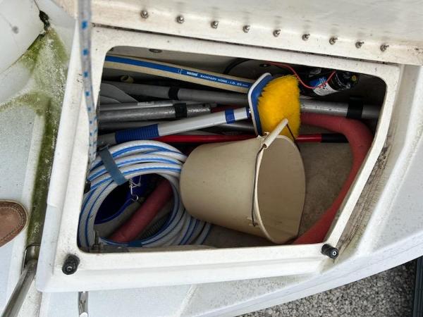 Slide: The Image of Storage compartment of a 1992 Hunter Legend 37 sailboat with cleaning supplies. - 27