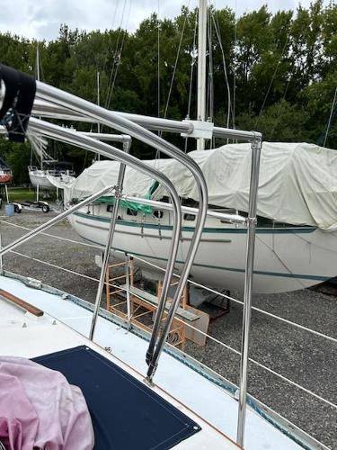 Slide: The Image of 1992 Hunter Legend 37 sailboat in a boatyard, covered and docked. - 34