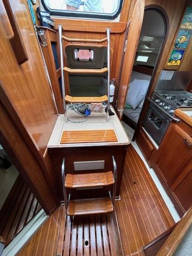 Slide: The Image of 1992 Hunter Legend 37 sailboat interior with wooden steps and galley. - 9