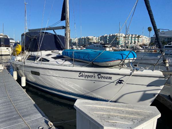 Slide: The Image of Hunter Passage 420 sailboat named "Skipper's Dream" docked at a marina, 2000 model. - 0