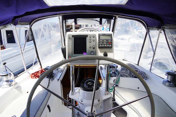 Slide: The Image of Cockpit of 2000 Hunter Passage 420 sailboat with navigation equipment and steering wheel. - 13