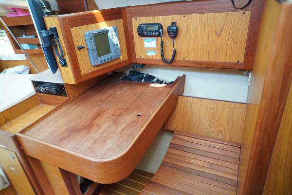 Slide: The Image of Navigation station on 2000 Hunter Passage 420 sailboat with wooden desk and communication equipment. - 17