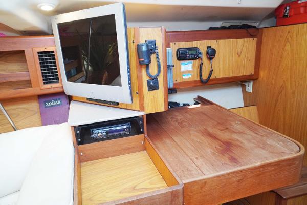 Slide: The Image of Interior of 2000 Hunter Passage 420 yacht with navigation equipment and wooden cabinetry. - 18