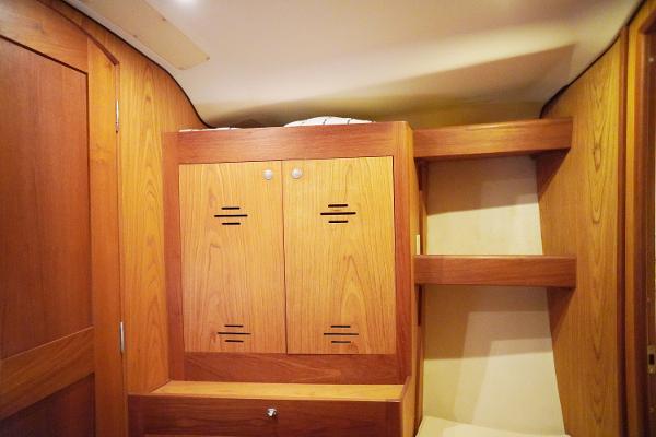 Slide: The Image of Interior cabin of 2000 Hunter Passage 420 sailboat with wooden cabinetry and shelving. - 21