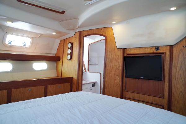 Slide: The Image of Interior of 2000 Hunter Passage 420 yacht with wood paneling and cozy cabin. - 22