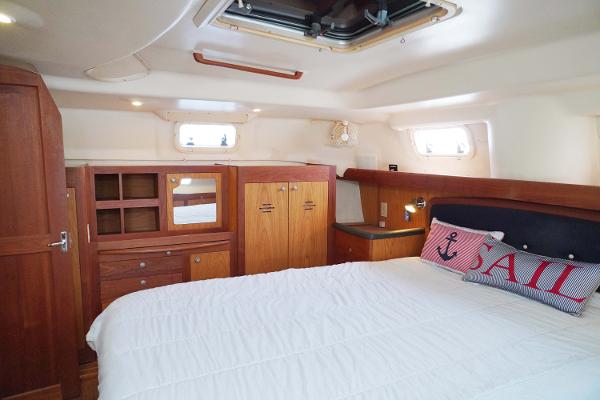 Slide: The Image of Interior of 2000 Hunter Passage 420 yacht with cozy bedroom and wooden cabinetry. - 23