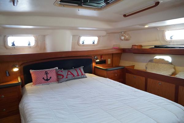 Slide: The Image of Cozy cabin interior of 2000 Hunter Passage 420 sailboat with nautical-themed decor. - 24