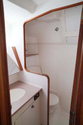 Slide: The Image of Bathroom interior of 2000 Hunter Passage 420 sailboat, featuring sink and toilet. - 26