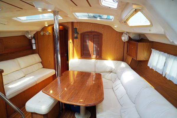 Slide: The Image of Interior of 2000 Hunter Passage 420 yacht with wooden table and white seating. - 29