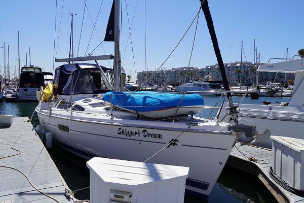 Slide: The Image of Hunter Passage 420 sailboat docked at marina, named "Skipper's Dream," with clear blue sky. - 3