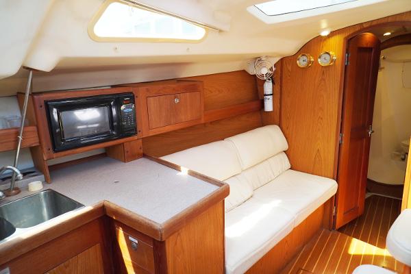Slide: The Image of Interior of 2000 Hunter Passage 420 yacht with kitchenette and seating area. - 30