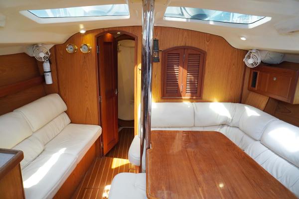 Slide: The Image of Interior of 2000 Hunter Passage 420 yacht with wooden furnishings and white seating. - 31