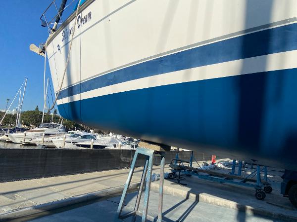 Slide: The Image of Hunter Passage 420 sailboat from 2000 on dry dock, with blue and white hull. - 7