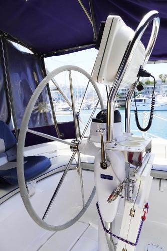 Slide: The Image of Steering wheel of 2000 Hunter Passage 420 yacht with marina background. - 9