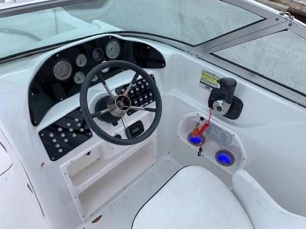 Slide: The Image of 2004 Hurricane 187SD boat dashboard with steering wheel and control panel. - 15