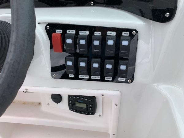 Slide: The Image of Control panel of a 2004 Hurricane 187SD boat with various switches and a digital display. - 16