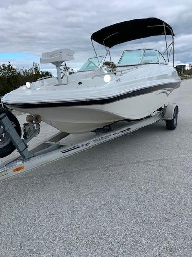 Slide: The Image of 2004 Hurricane 187SD boat on trailer with black canopy. - 2