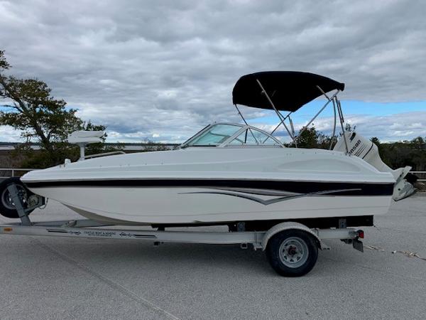 Slide: The Image of 2004 Hurricane 187SD boat on trailer with black canopy. - 3