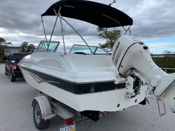 Slide: The Image of 2004 Hurricane 187SD boat with Johnson outboard motor on trailer. - 4