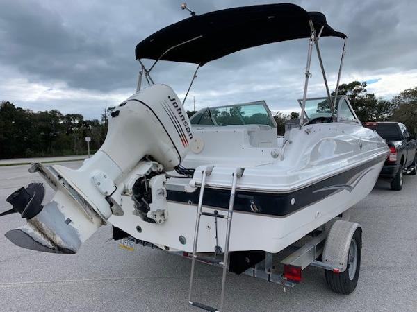 Slide: The Image of 2004 Hurricane 187SD boat with Johnson outboard motor on trailer. - 7
