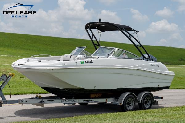 Slide: The Image of 2020 Hurricane 217 SD boat on trailer, Off Lease Boats logo, grassy background. - 0