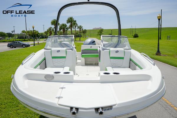 Slide: The Image of 2020 Hurricane 217 SD boat with green accents, parked on a sunny day. - 3
