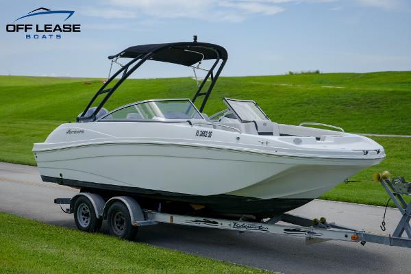 Slide: The Image of 2020 Hurricane 217 SD boat on trailer with black canopy, displayed by Off Lease Boats. - 3