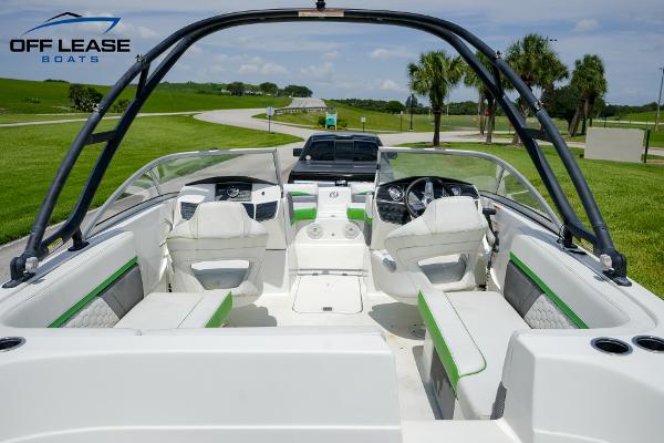 Slide: The Image of 2020 Hurricane 217 SD boat interior with green accents, parked on a sunny day. - 4