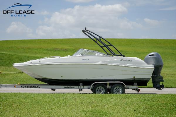 Slide: The Image of 2020 Hurricane 217 SD boat on trailer, grassy background, clear sky. - 6