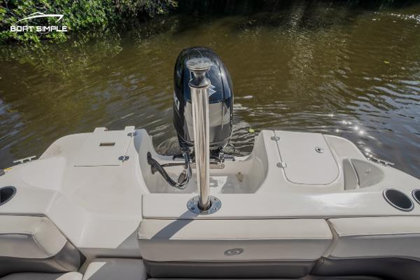 Slide: The Image of 2022 Hurricane 217 SD boat stern with outboard motor on water. - 12