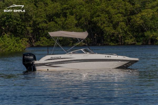 Slide: The Image of 2022 Hurricane 217 SD boat on calm water with Suzuki outboard motor. - 4