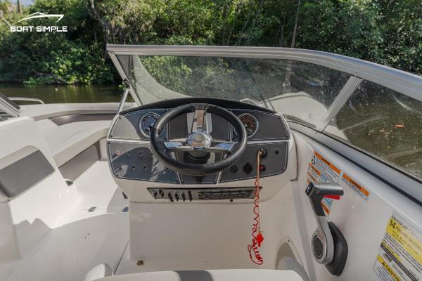Slide: The Image of 2022 Hurricane 217 SD boat dashboard with steering wheel and controls. - 7