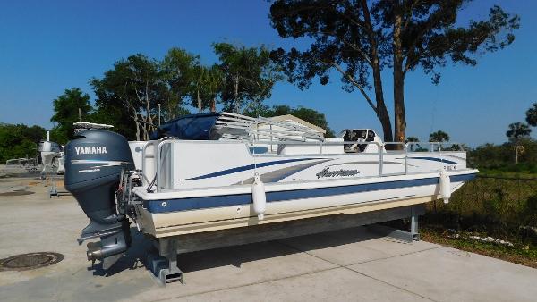 Slide: The Image of 2006 Hurricane 22 Deck Boat with Yamaha outboard motor on a concrete dock. - 1