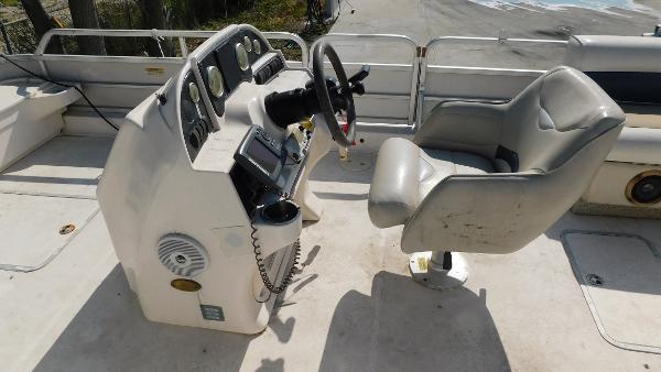 Slide: The Image of 2006 Hurricane 22 Deck Boat cockpit with steering wheel and captain's chair. - 10