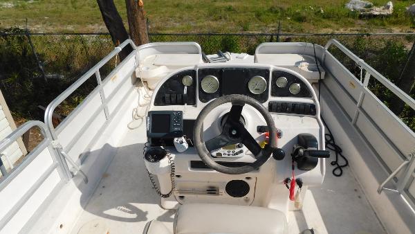 Slide: The Image of 2006 Hurricane 22 Deck Boat cockpit with steering wheel and control panel. - 15