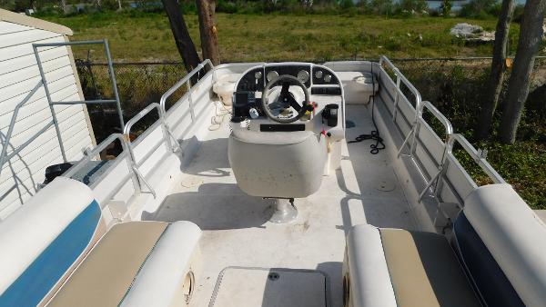 Slide: The Image of 2006 Hurricane 22 Deck Boat interior with seating and steering console. - 16
