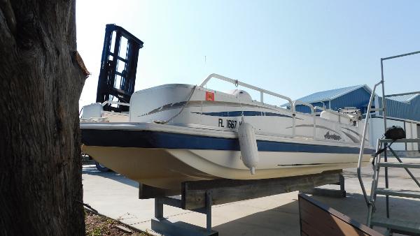Slide: The Image of 2006 Hurricane 22 Deck Boat on a lift at a marina. - 4