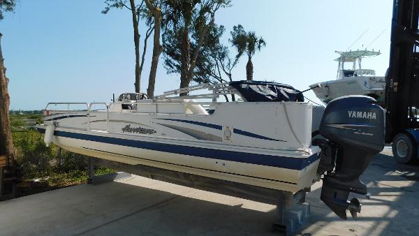 Slide: The Image of 2006 Hurricane 22 Deck Boat with Yamaha outboard motor on a lift. - 5