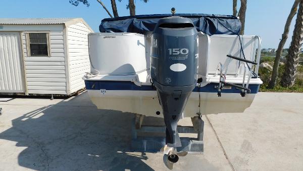 Slide: The Image of 2006 Hurricane 22 Deck Boat with Yamaha 150 outboard motor, parked on concrete. - 7