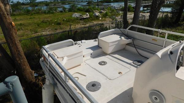 Slide: The Image of 2006 Hurricane 22 Deck Boat with spacious deck and seating, near a scenic waterfront. - 9
